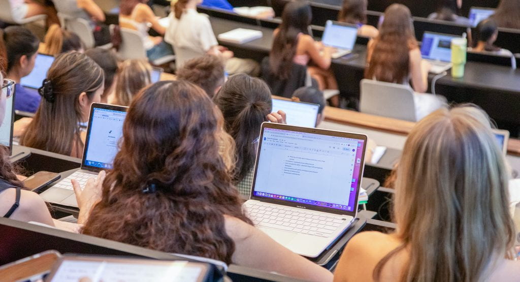 Students on computers in lecture hall