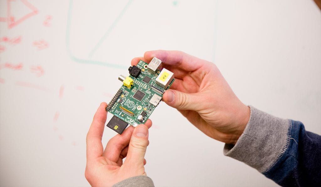 Close up of hands holding circuit board